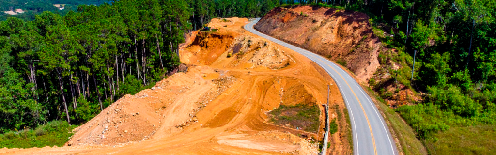 Learn about the common land development challenges in North Georgia, including sloped terrain, rocky soil, drainage concerns, and excavation planning.