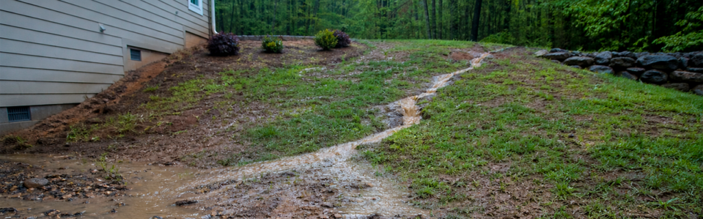 Learn about common drainage problems on sloped properties in North Georgia and how grading, erosion control, and proper land management can help prevent damage and improve stability.