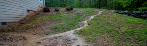 Learn about common drainage problems on sloped properties in North Georgia and how grading, erosion control, and proper land management can help prevent damage and improve stability.