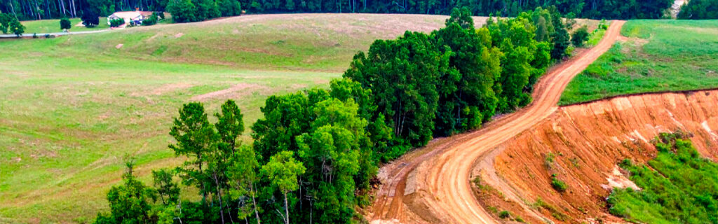 Extended rainfall transforms Cherokee County clay soil into a fundamentally different material. Learn how that transformation affects drainage, equipment access, slopes, and trees in North Georgia.