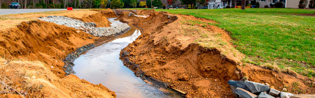 Water on a North Georgia property flows where terrain directs it — not where the excavation designer would prefer. Learn how to evaluate existing drainage patterns before excavation planning to produce improvements that perform through every season in Cherokee County.