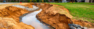 Water on a North Georgia property flows where terrain directs it — not where the excavation designer would prefer. Learn how to evaluate existing drainage patterns before excavation planning to produce improvements that perform through every season in Cherokee County.