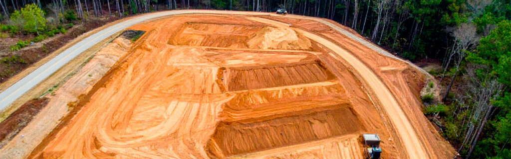 A sloped Cherokee County property is not a flat property with inconvenient terrain — it is a fundamentally different site context requiring fundamentally different planning. Learn how slope specifically affects drainage, earthwork, access, and usable space decisions in North Georgia.