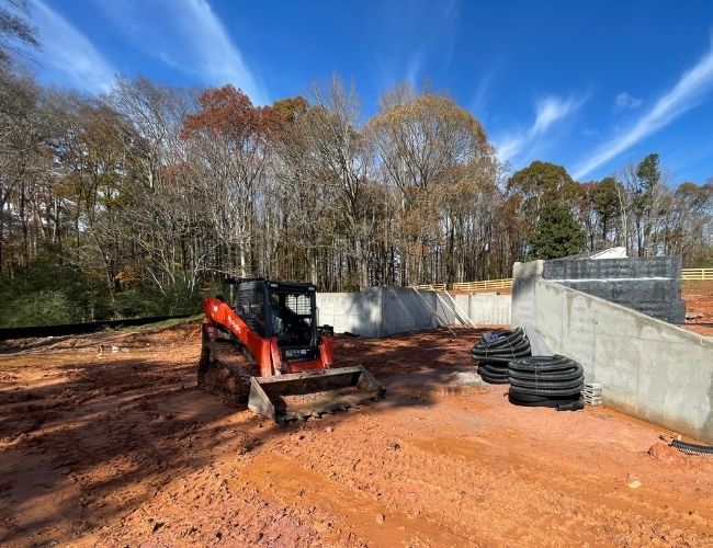 Grading and excavation equipment leveling soil